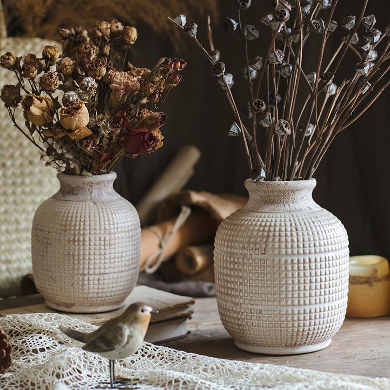 White textured ceramic jar vase with narrow neck and rounded body