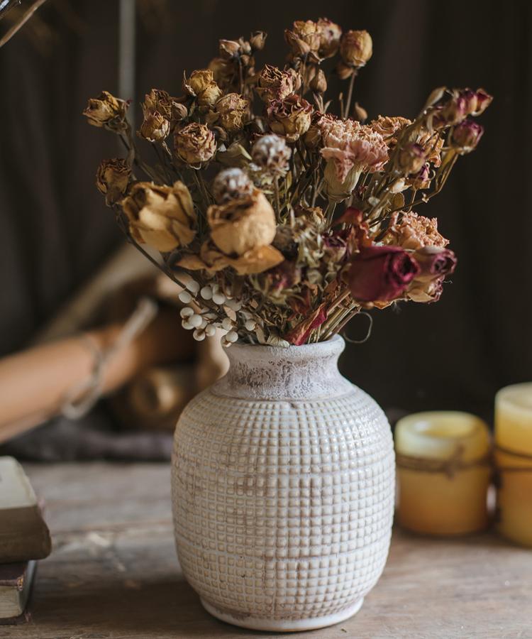 Textured ceramic jar vase with open mouth, speckled rim, and bulb form