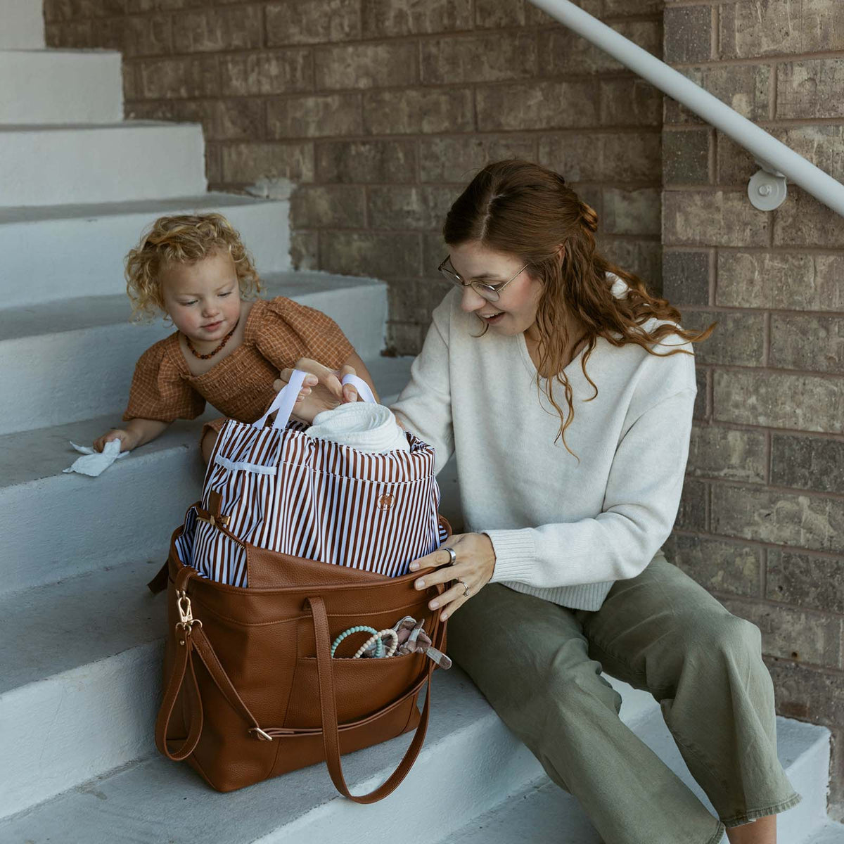 Chestnut brown tote bag with double handles and adjustable wrist strap