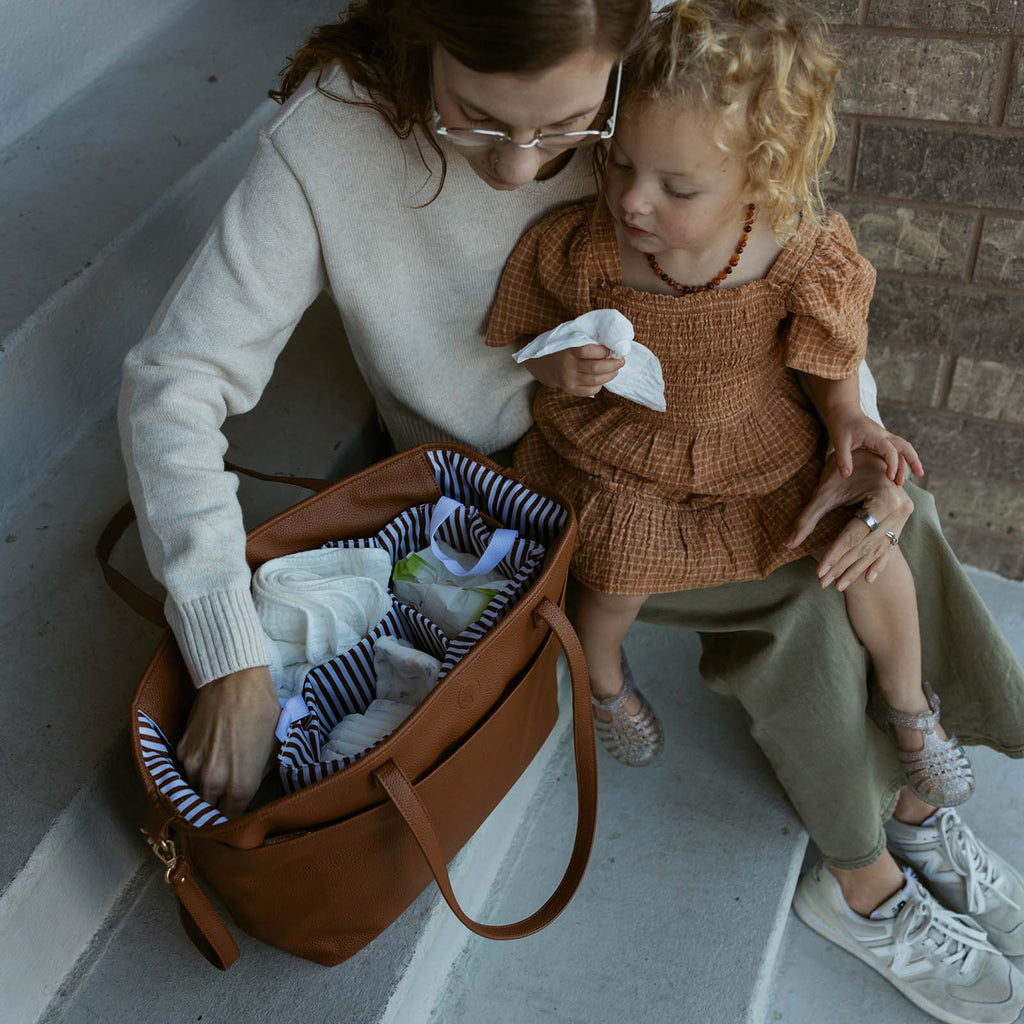 Chestnut brown open tote bag with striped lining and front zipper pocket