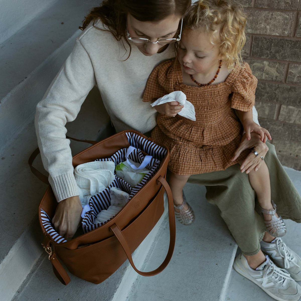Chestnut brown open tote bag with striped lining and front zipper pocket