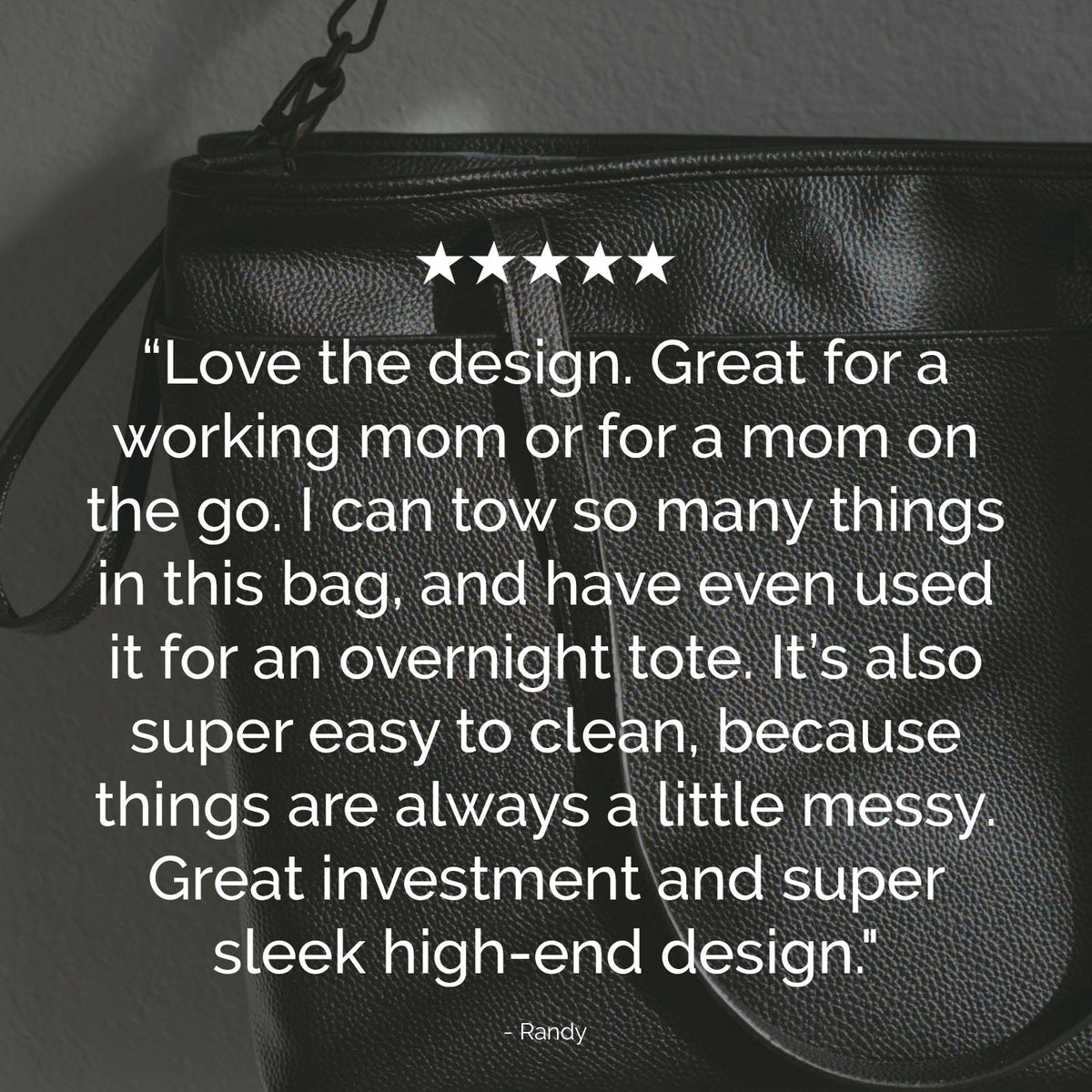 Black faux-leather tote bag with textured finish and top zipper edge