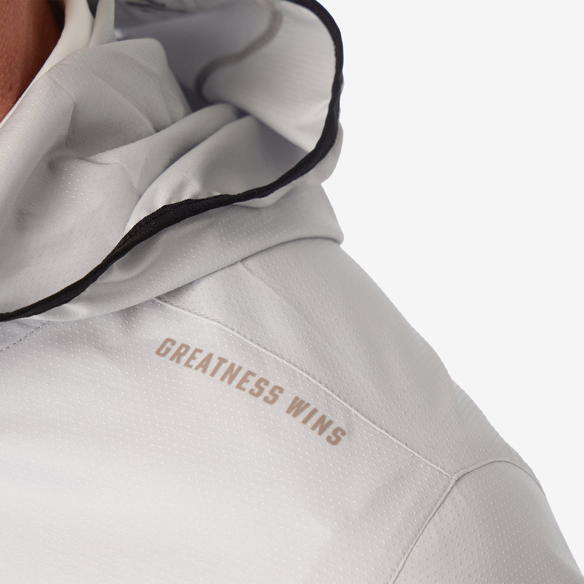 Ash gray windbreaker jacket with "GREATNESS WINS" logo on chest