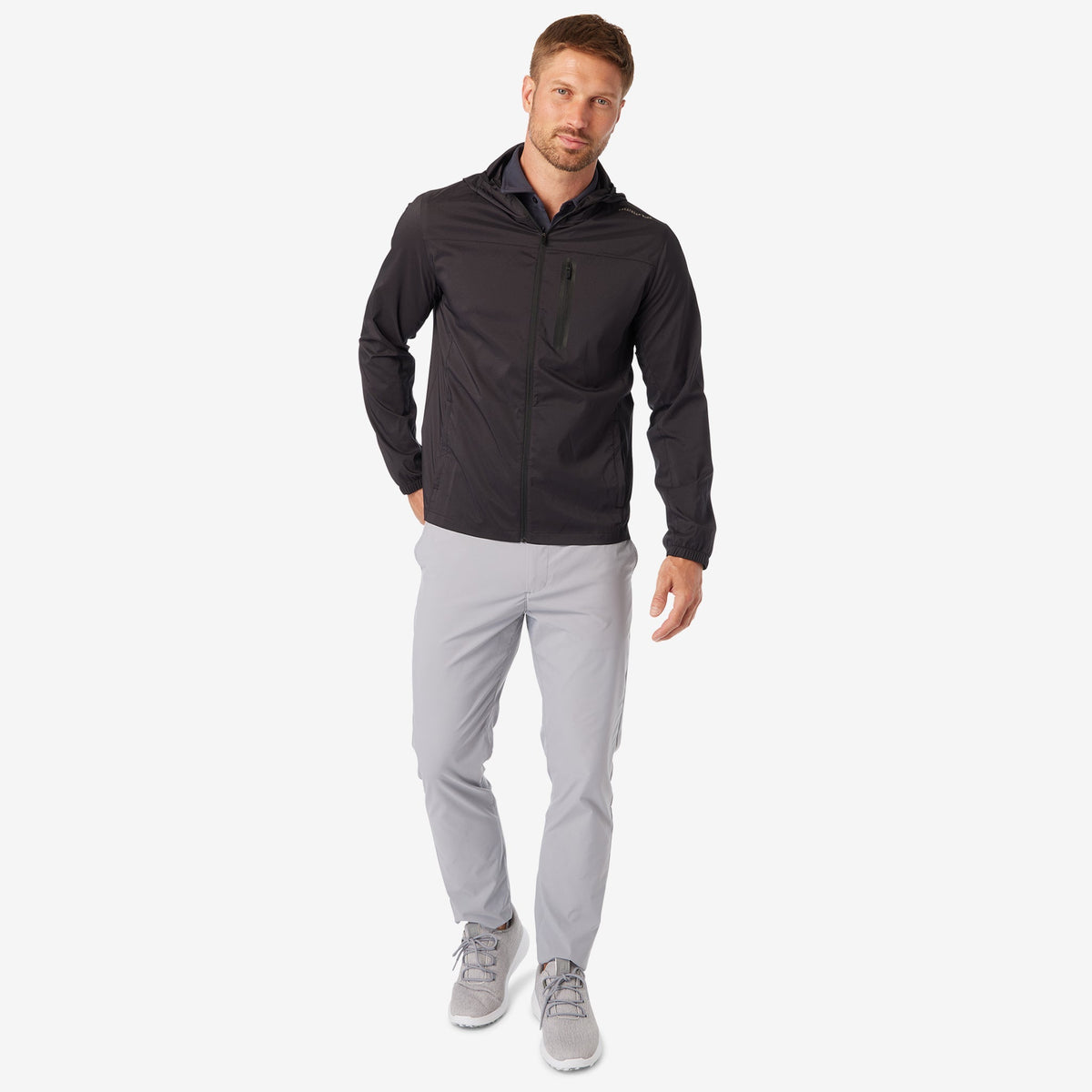 Black windbreaker jacket with hood, full-zip front, and hip pockets, standing pose