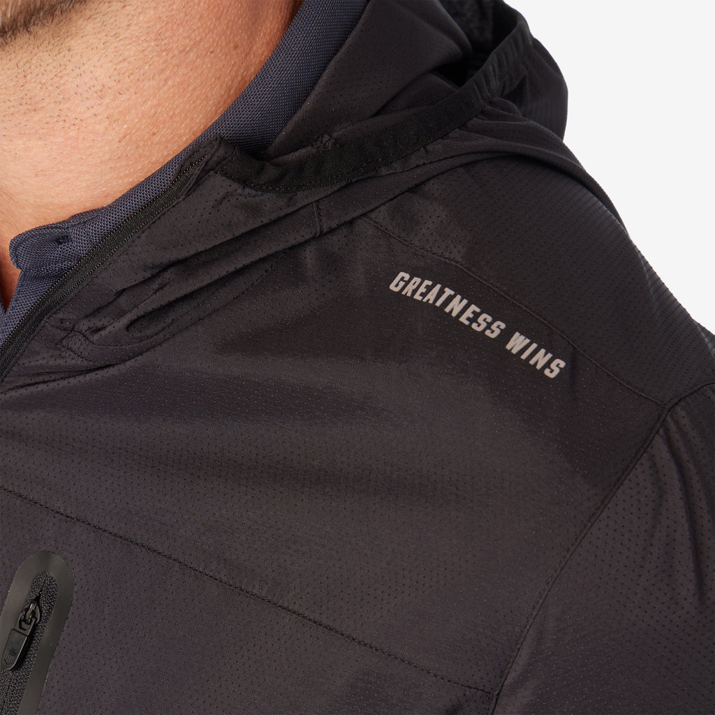 Black windbreaker chest logo "GREATNESS WINS" on hooded jacket panel