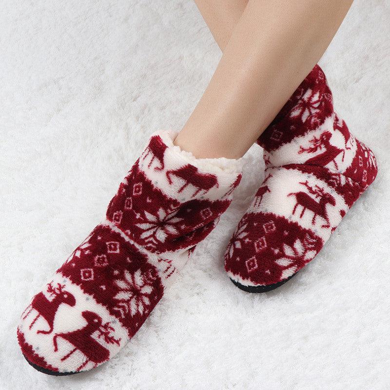 Red and white plush slipper boots with reindeer snowflake pattern and cushioned lining