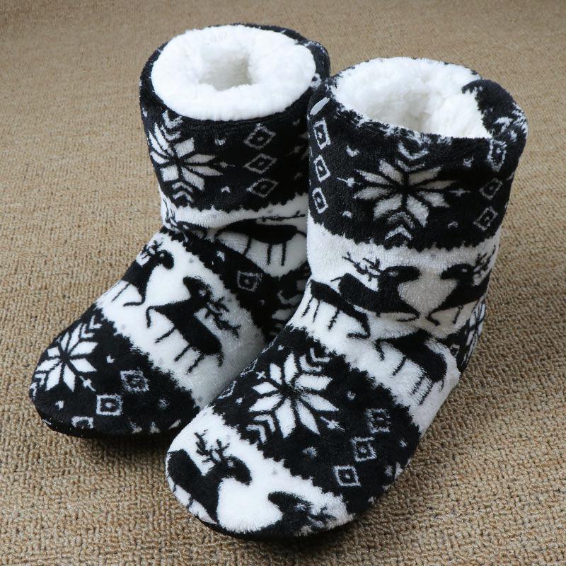 Black and white knit fleece slipper boots with plush lining and winter reindeer pattern
