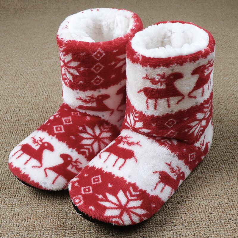 Red and white fleece slipper boots with plush lining and reindeer snowflake pattern