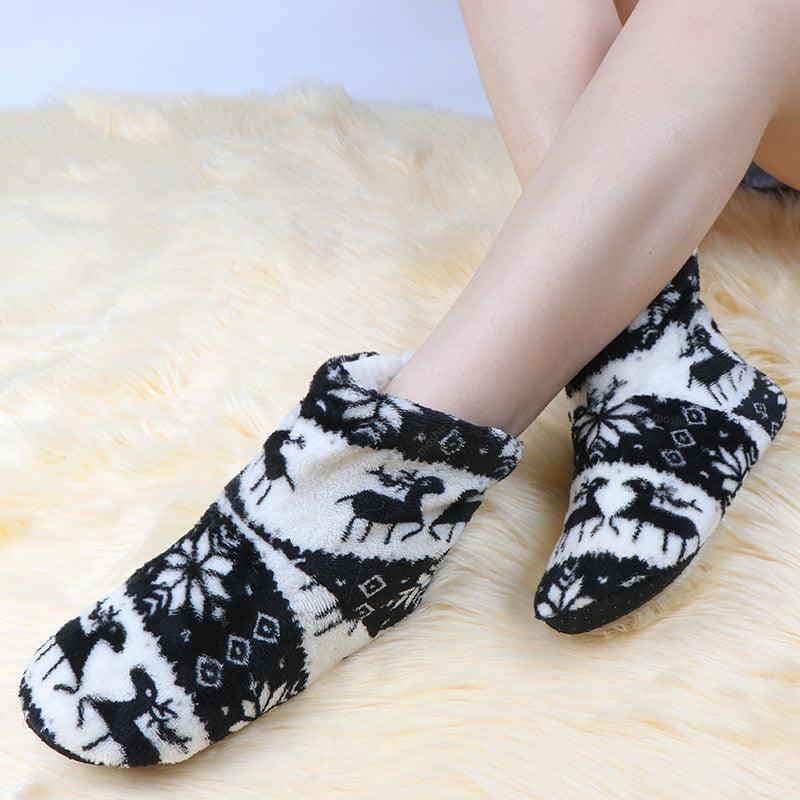 Black and white plush slipper boots with winter reindeer print and thick soft lining