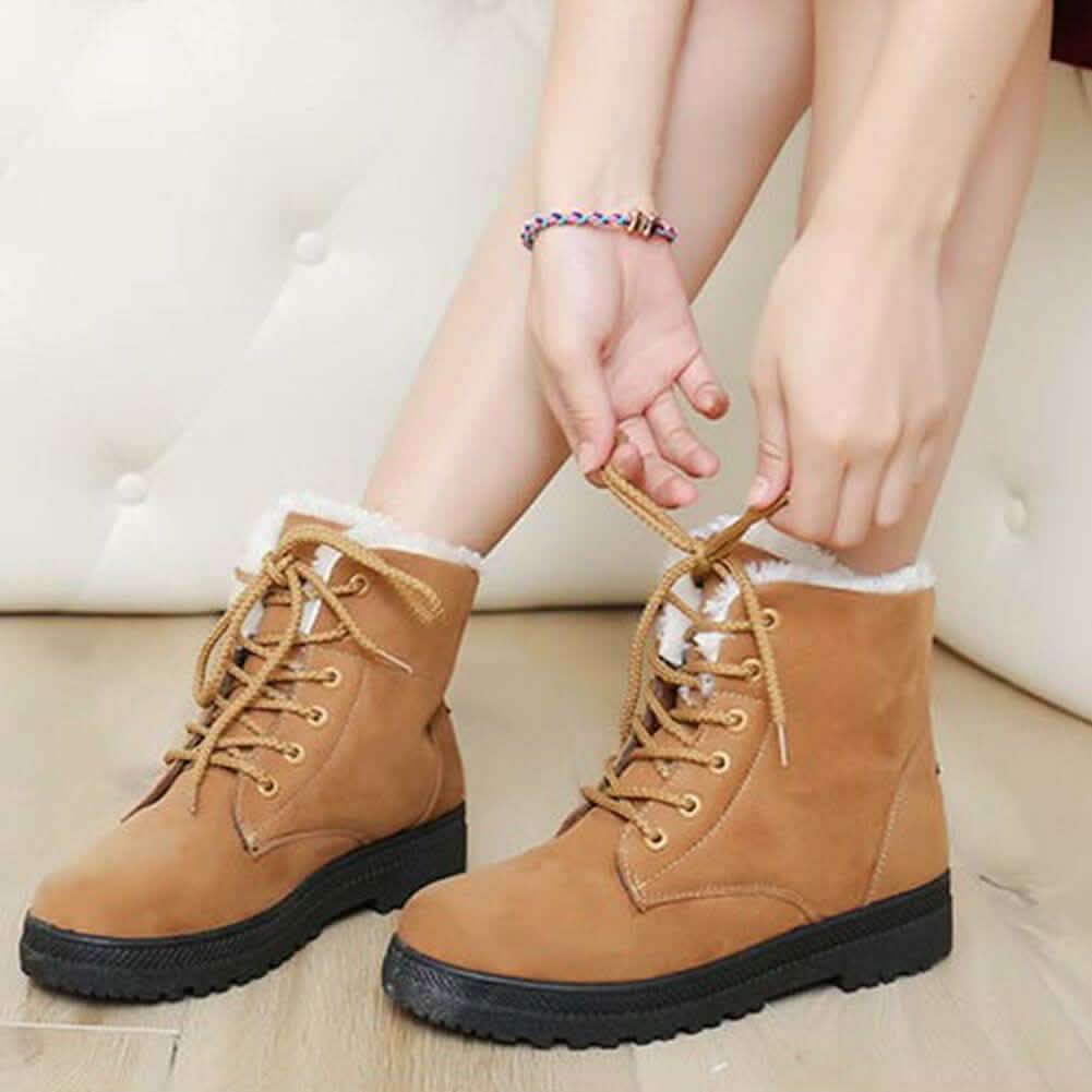 Tan lace-up winter ankle boots with faux-fur lining and chunky black tread sole