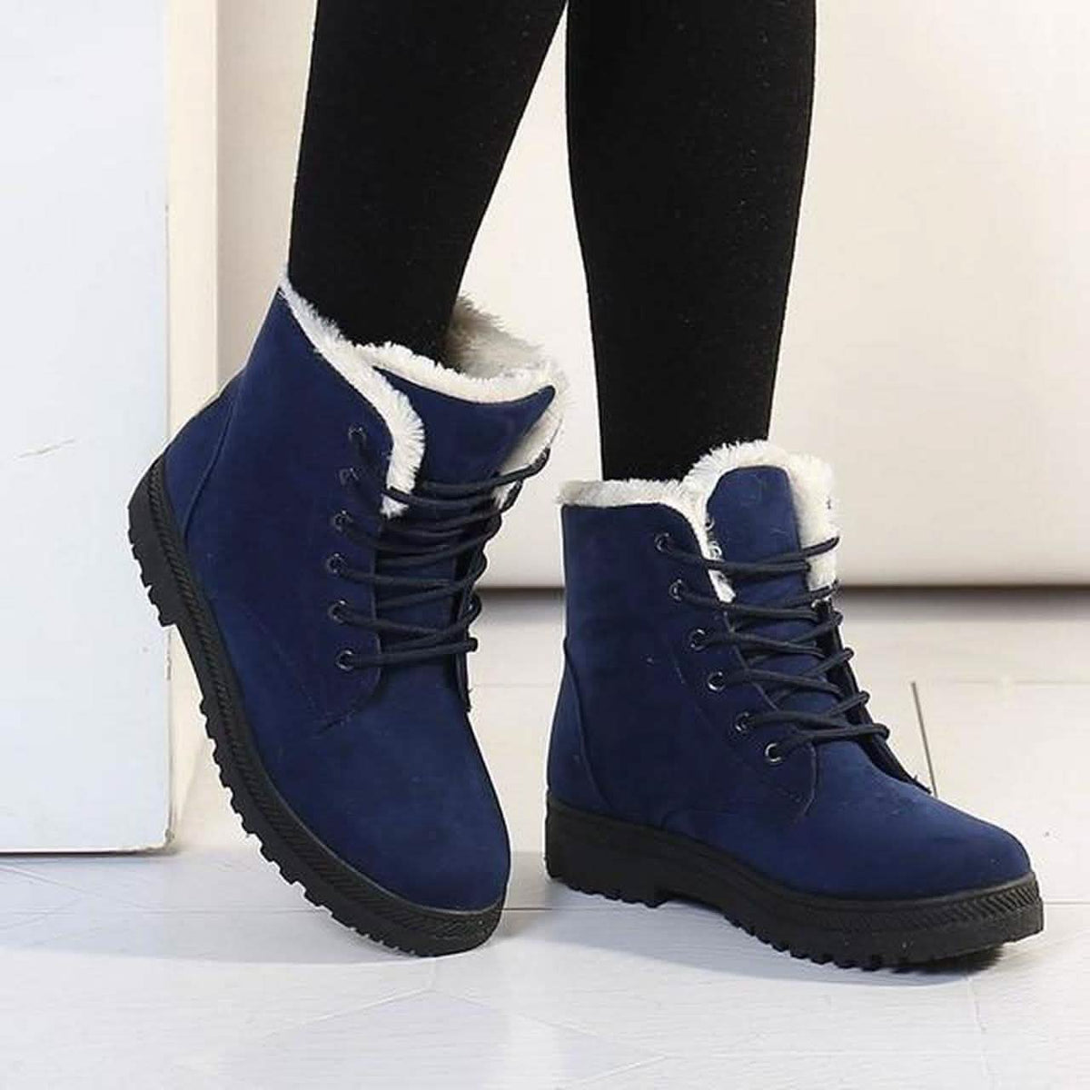 Blue winter ankle boots with lace-up front, padded collar, and dark rubber sole