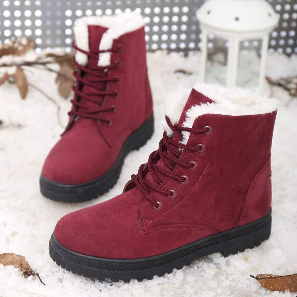 Pair of deep red winter short flat boots with lace-up design and white sherpa collar