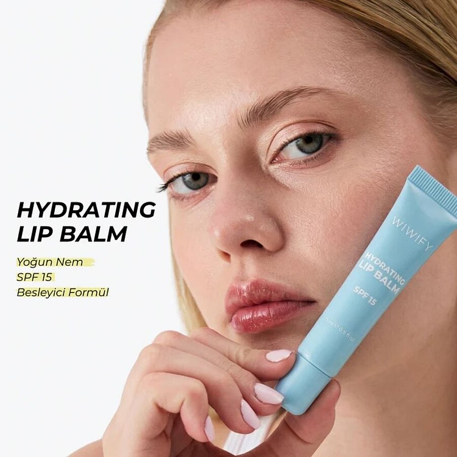 Hydrating lip balm SPF 15 applied on lips with light blue tube, glossy look.