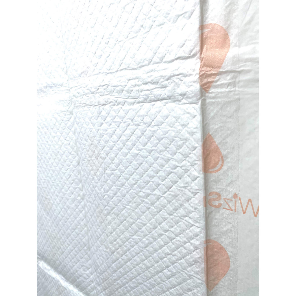 Close-up of white dog training pad surface with embossed texture