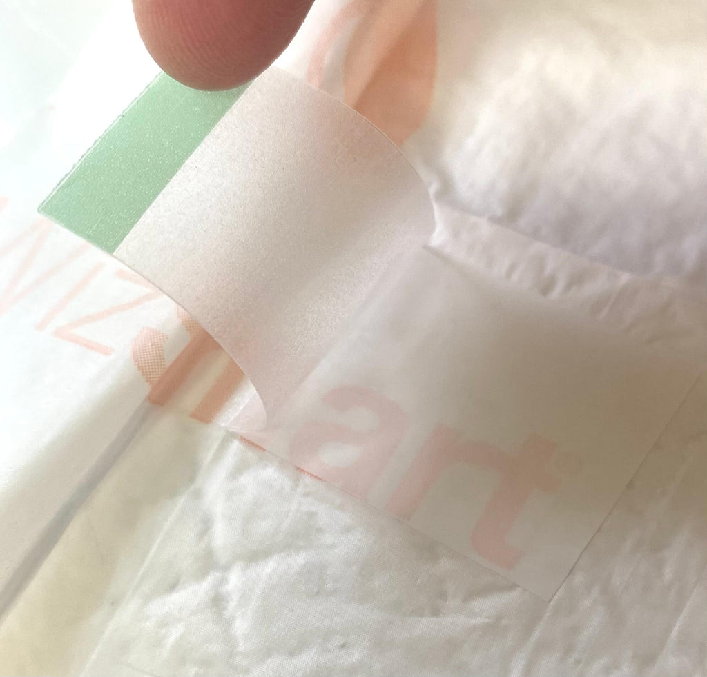 Close-up of top layer with green label edge and faint paw print pattern