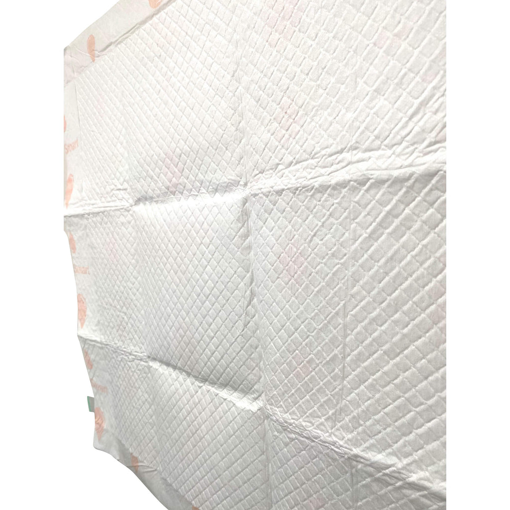 Side view of stacked dog training pads showing quilted absorbent layers