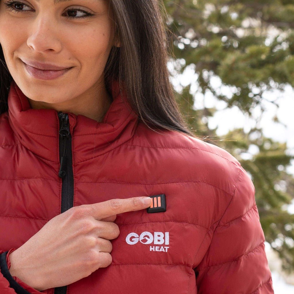 Women’s heated puffer jacket close-up: GOBI HEAT logo on zipper front