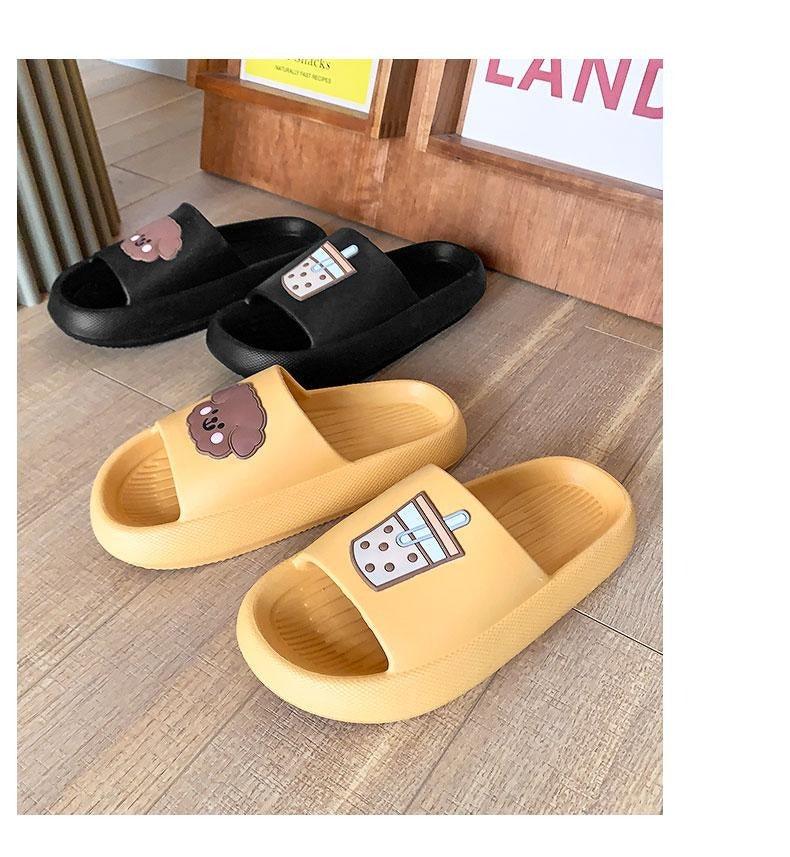 Women’s open-toe slide slippers in black and yellow with drink and paw patches