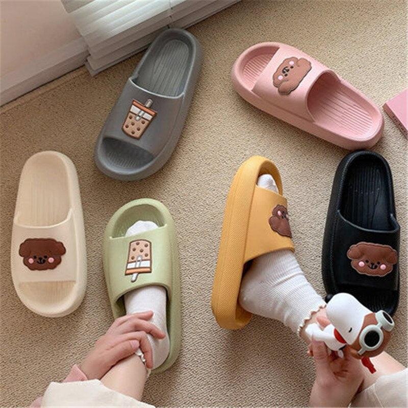 Set of women’s open-toe slide slippers in several colors with bear patch