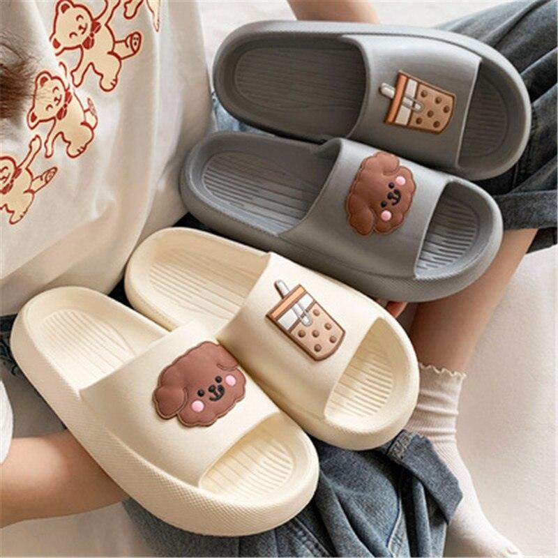 Women’s open-toe slide slippers in cream and gray with cute paw and drink charms