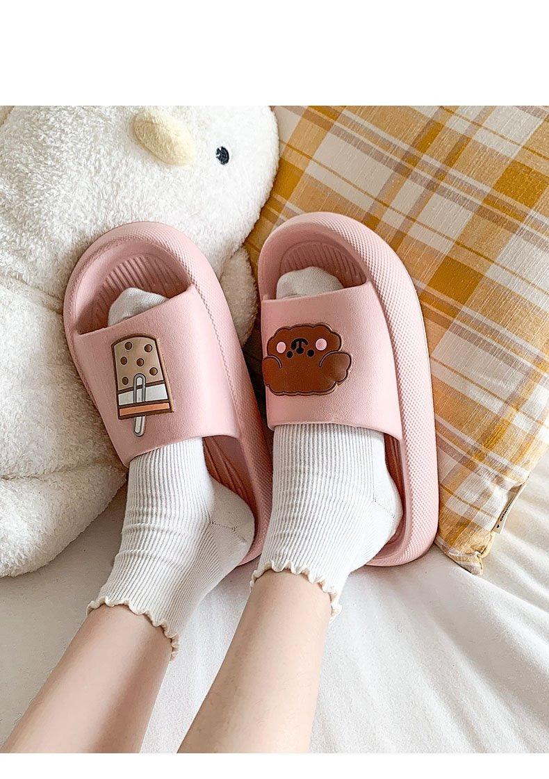 Women’s pink open-toe slide slippers with bear patch on the straps