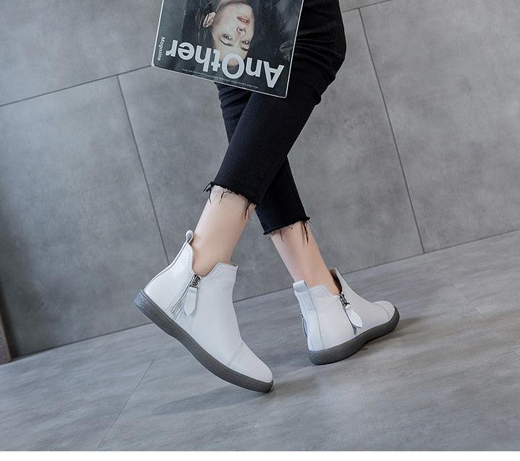 White ankle boots with side zipper, fur-lined interior, low cushioned sole for walking