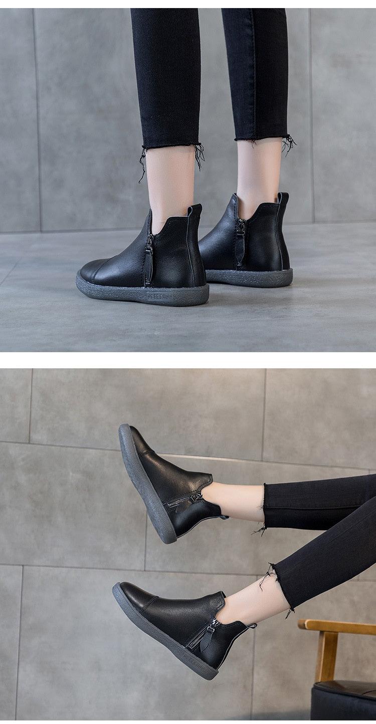 Black ankle boots with side openings and chunky sole (shown with pants hem)