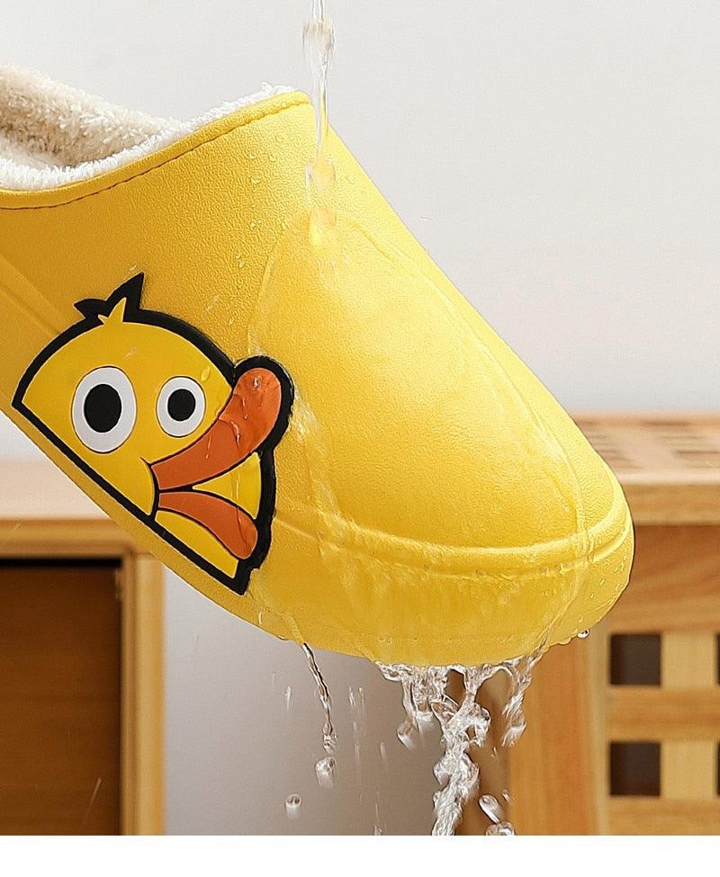 Yellow slide slippers with cartoon character graphic, showing water splash on upper