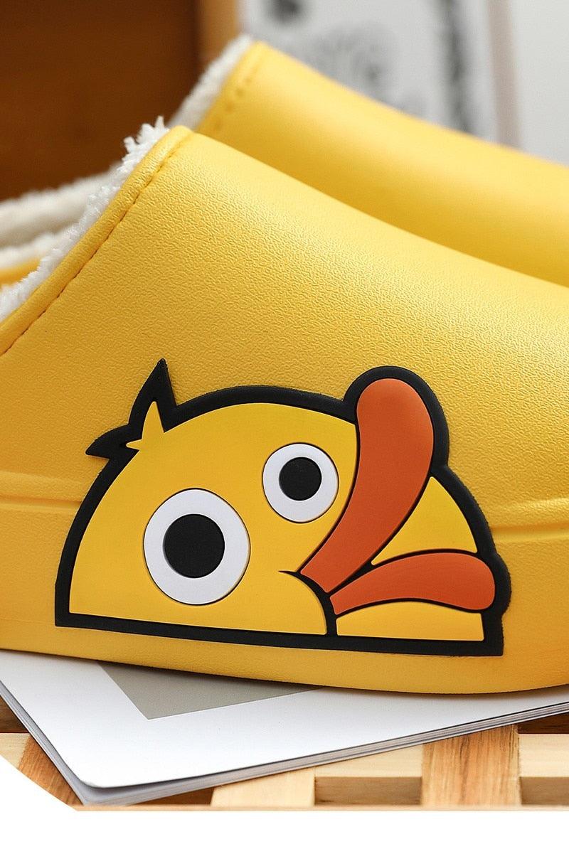 Close-up of yellow cartoon slides with fuzzy lining and thick sole.