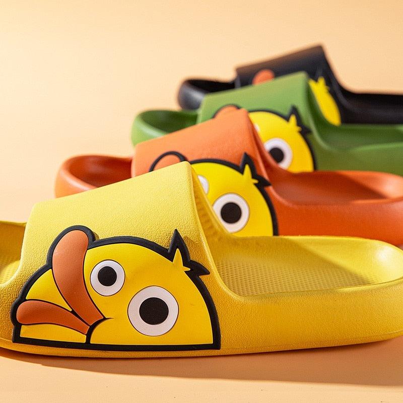 Yellow open-toe slide slippers with large cartoon character face patch