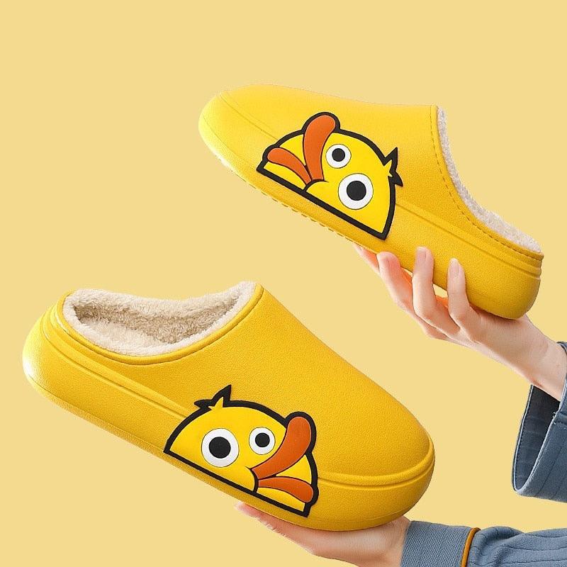 Yellow open-toe slide slippers with cartoon character patch; fuzzy lining visible