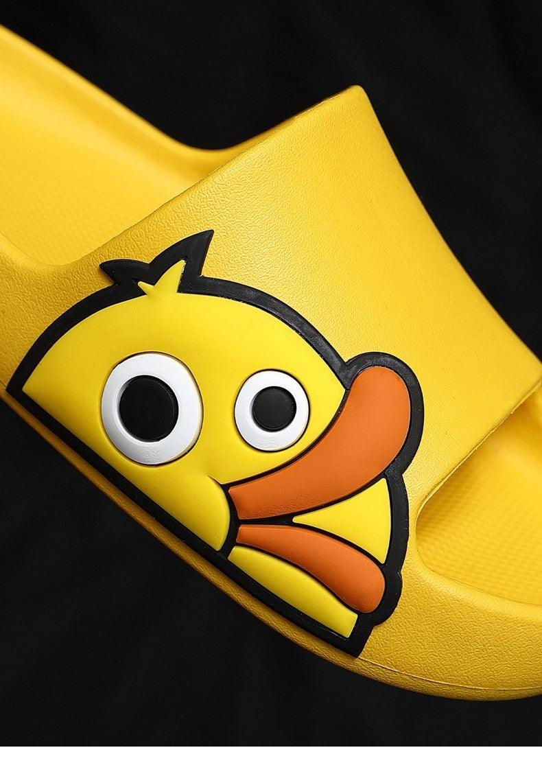 Yellow slide slippers with close-up cartoon character patch on top