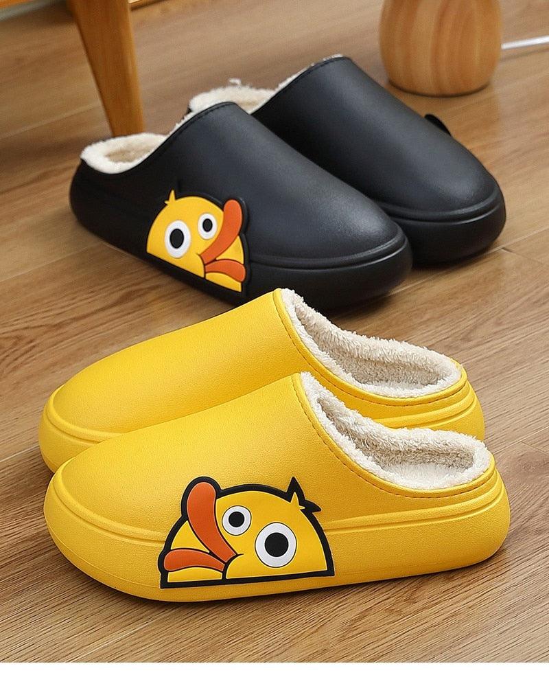 Pair of slide slippers: black and yellow with white fleece lining and cartoon patch
