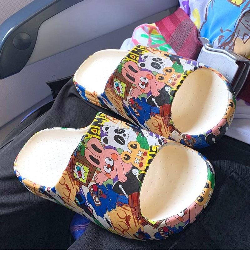 Cartoon slide sandals with multicolor character print, open toe and cushioned footbed
