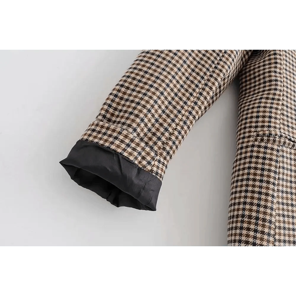 Plaid blazer sleeve cuff close-up with dark inner lining
