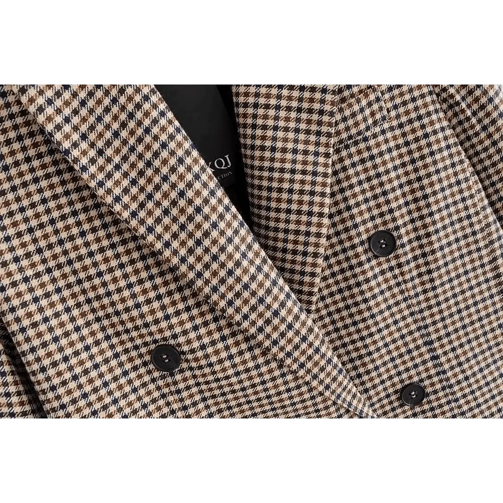 Plaid blazer close-up showing double-breasted black buttons and lapel opening