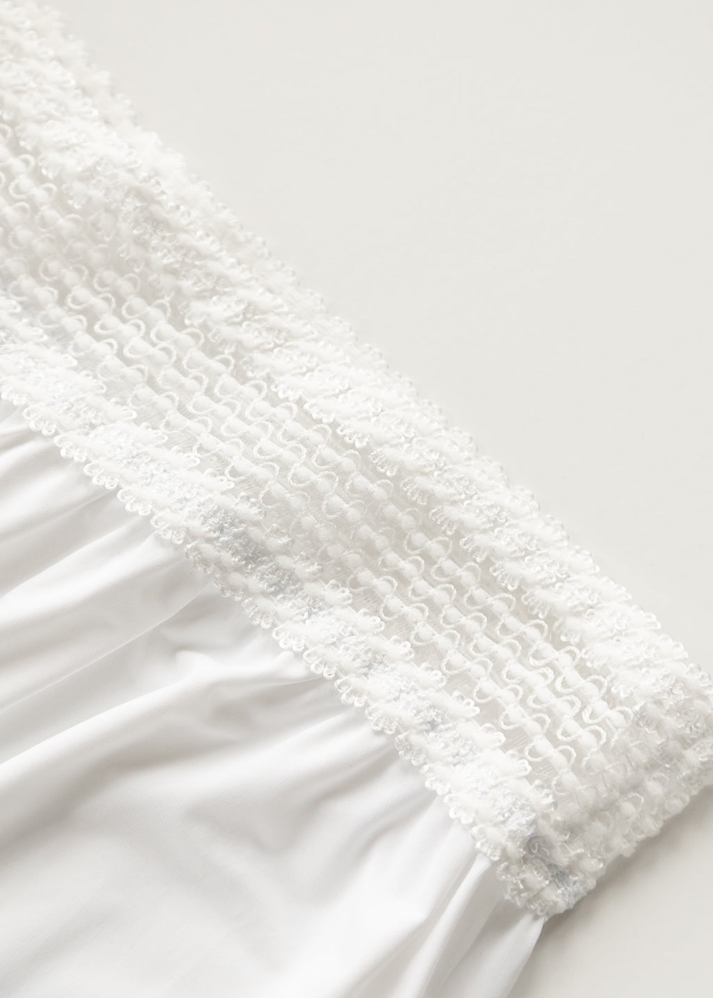 White half slip with lace trim along the upper edge and elastic band