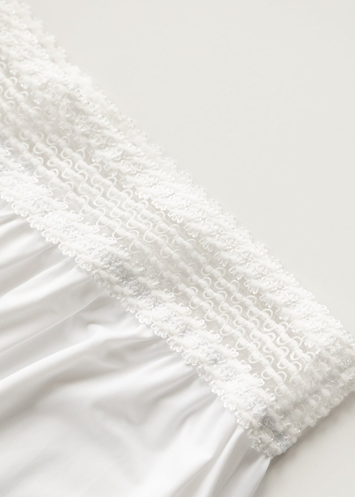 White half slip with lace trim along the upper edge and elastic band