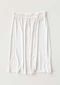 White half slip with elastic waistband and gathered skirt, mid-thigh length
