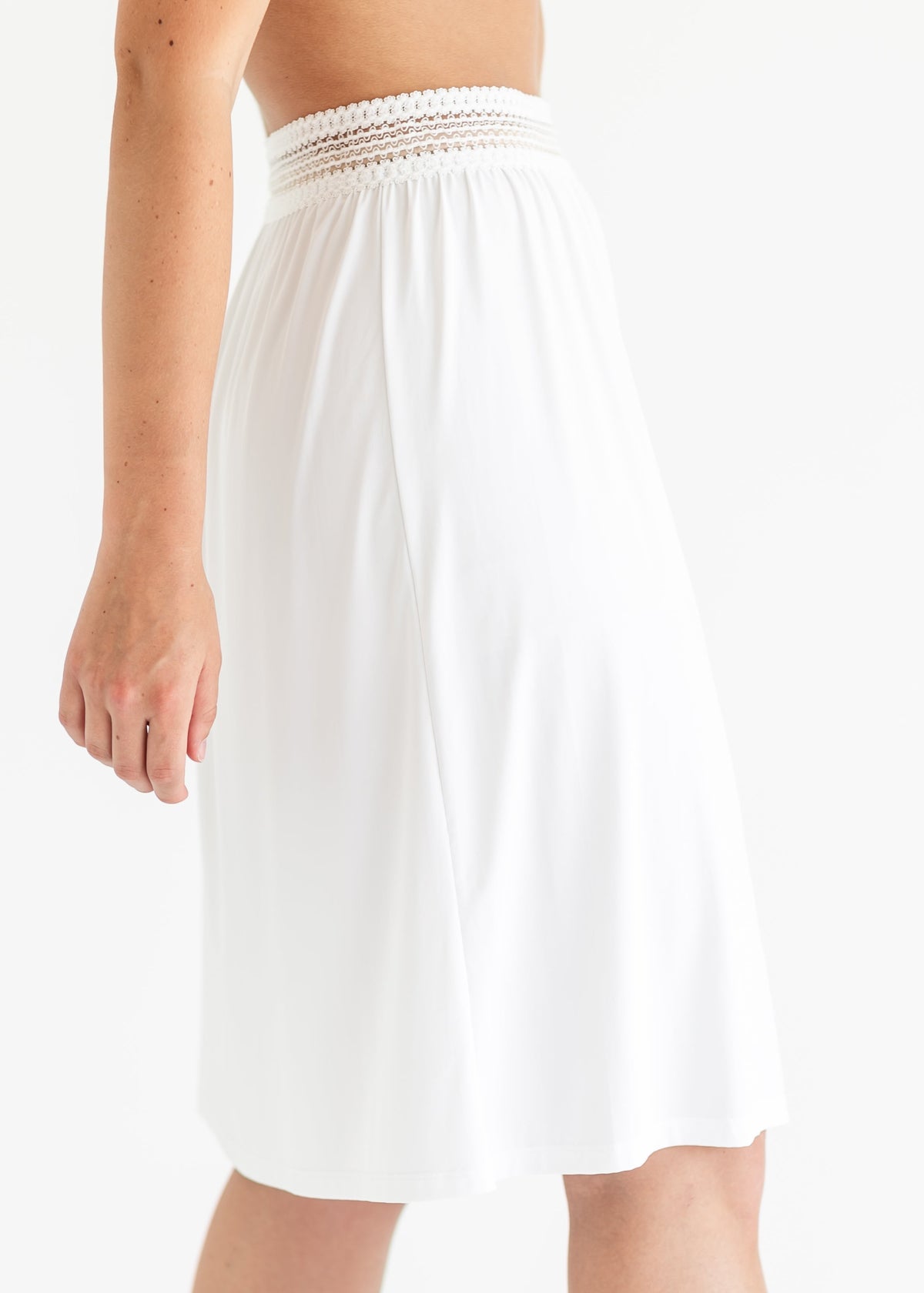 White half slip with elastic waist and gathered flare to mid-thigh