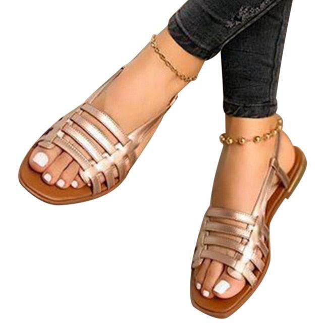Gold-toned strappy flat sandals with open toe and ankle slingback