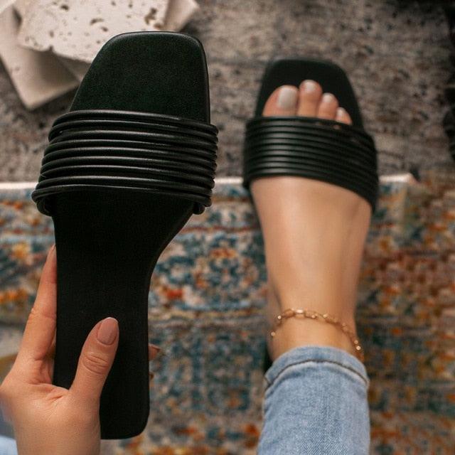 Black ribbed open-toe slide sandals with wide slingback strap