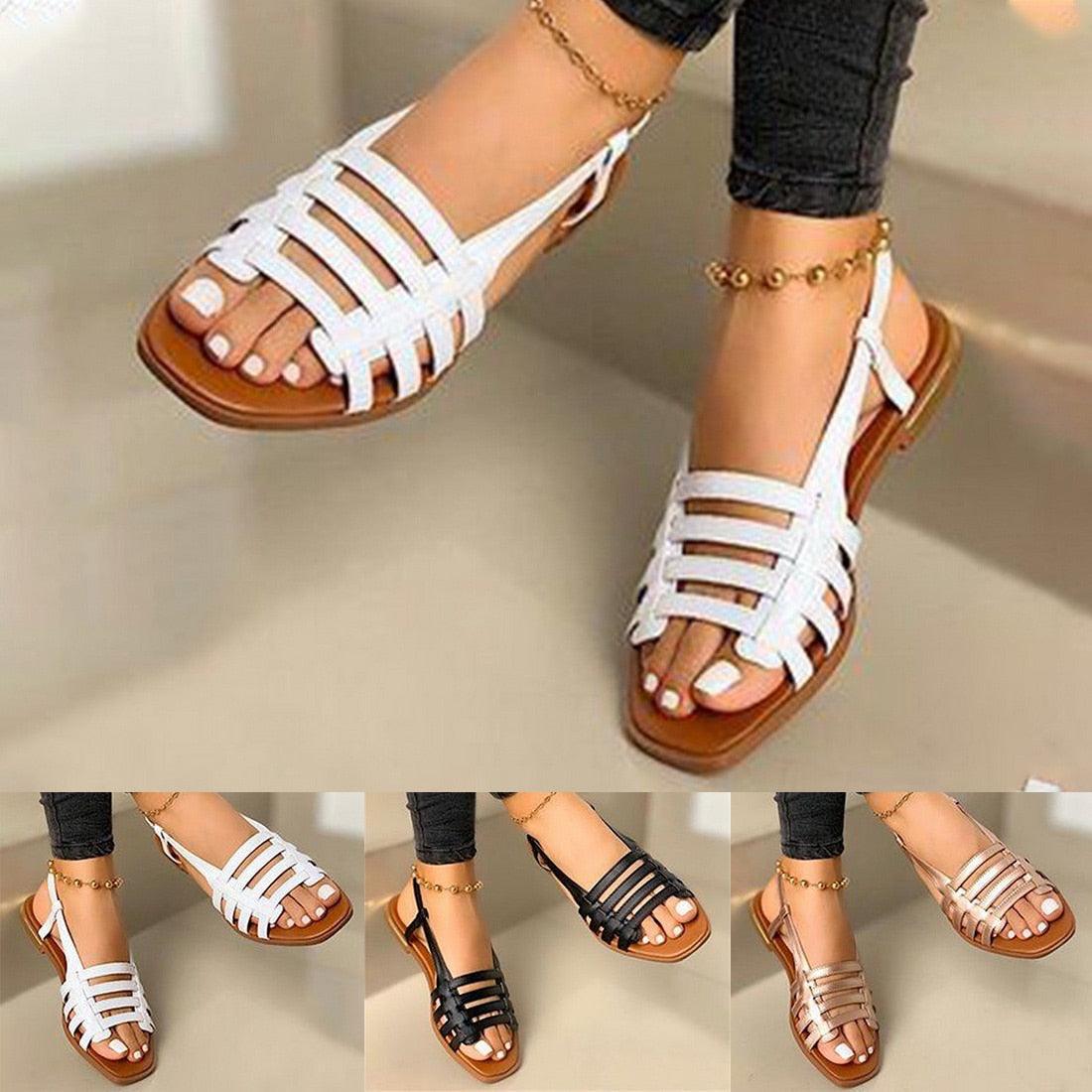 White strappy flat sandals with open toe and ankle slingback