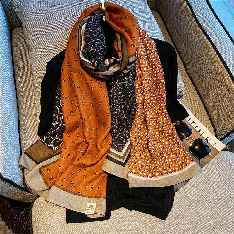 Women’s leopard print cotton scarf in orange and dark brown with fringe ends