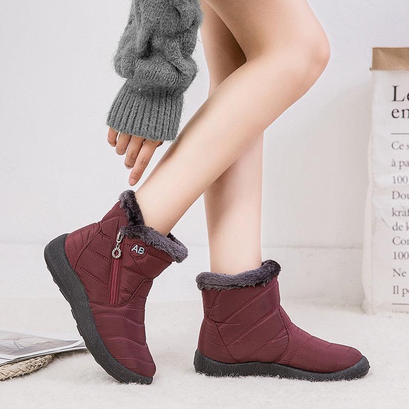Women’s winter ankle boots, burgundy with faux-fur cuffs and side zipper, worn with socks