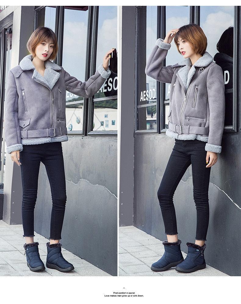 Gray sherpa-lined ankle boots with front zipper and grippy sole, on model