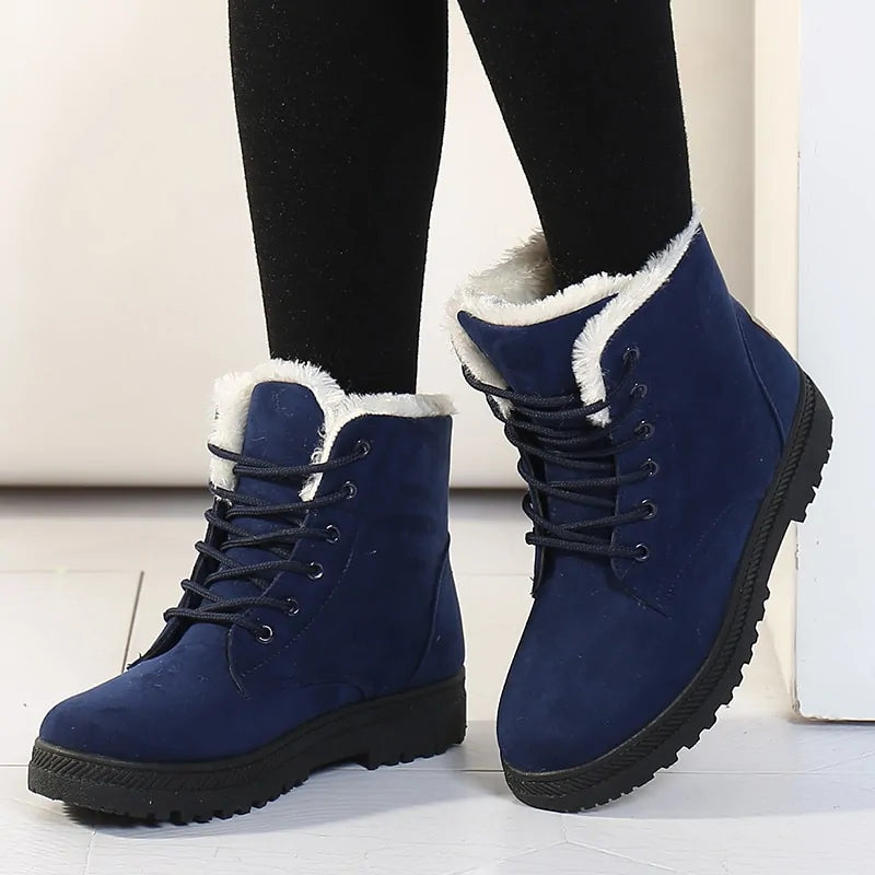 Blue ankle boots with lace-up front, white faux-fur trim, and thick tread sole