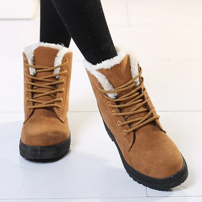 Tan lace-up ankle boots with white faux-fur cuff and rugged treaded rubber sole