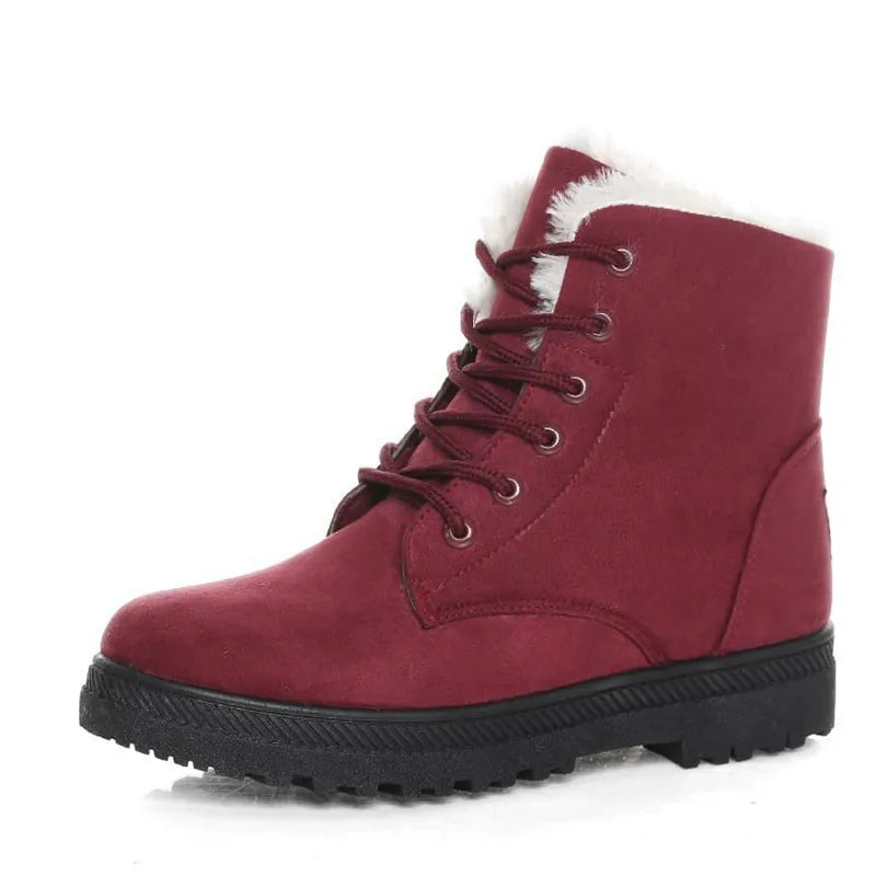 Red ankle boots with lace-up front, white faux-fur cuff, and chunky treaded outsole
