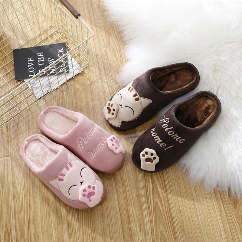 Pair of women’s cat slippers in pink and brown, plush lined slip-on style with paw prints